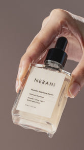  Hydrating serum gracefully dripping into a sleek bottle, highlighting its lightweight and nourishing texture.